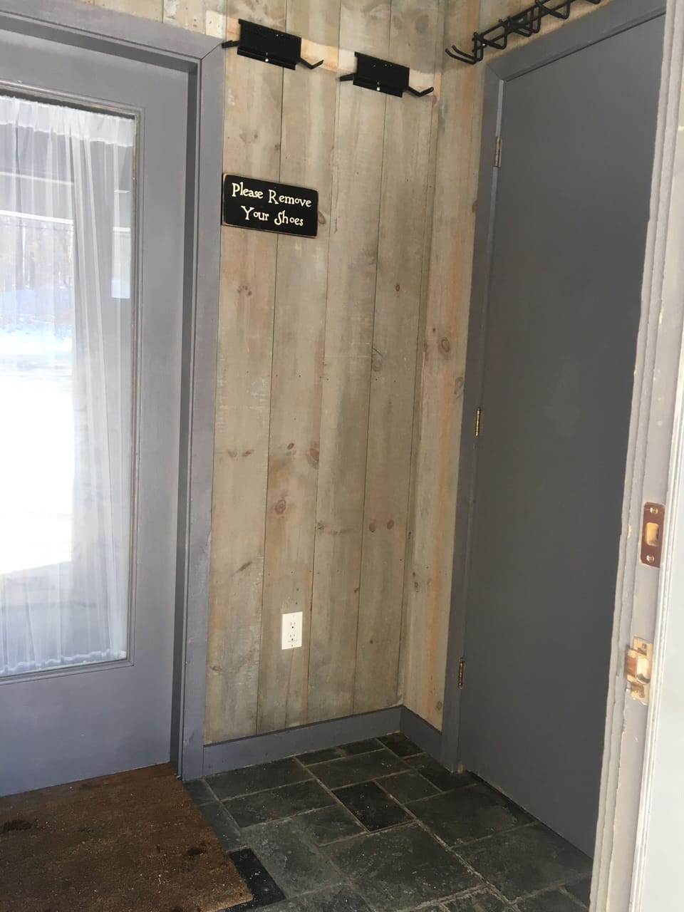 Foyer with a closet and tons of hooks for all of your ski equipment