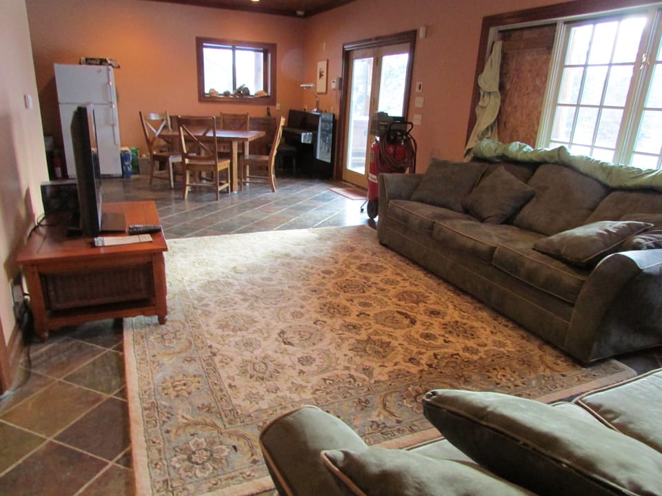 Basement family room, piano, game table, and second refrigerator