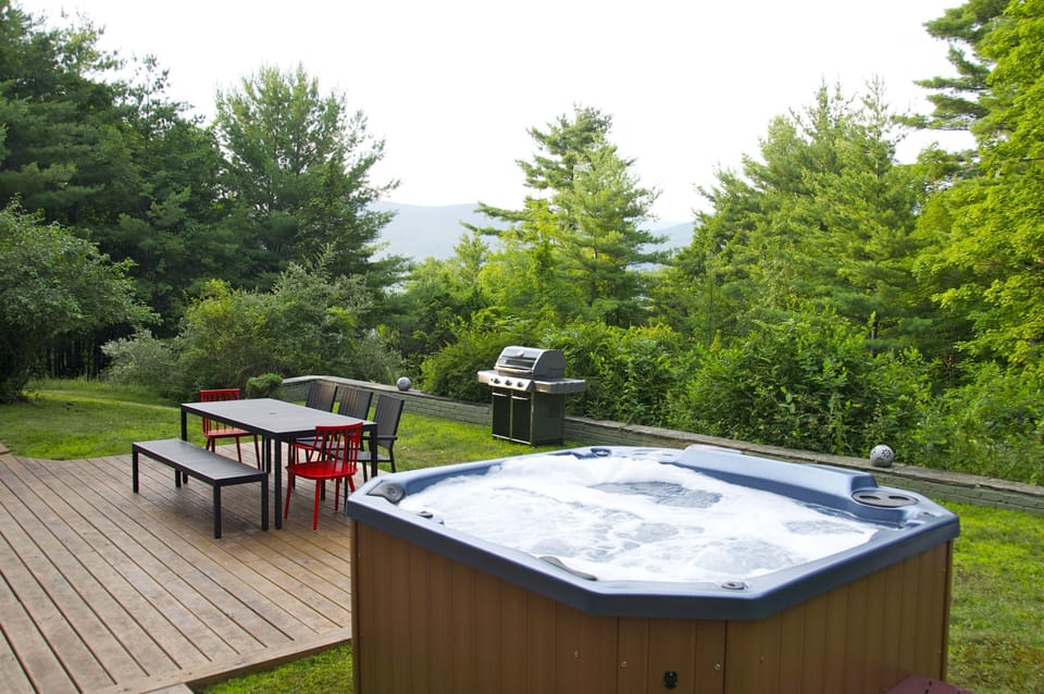 Hot tub, grill, and outdoor dining space