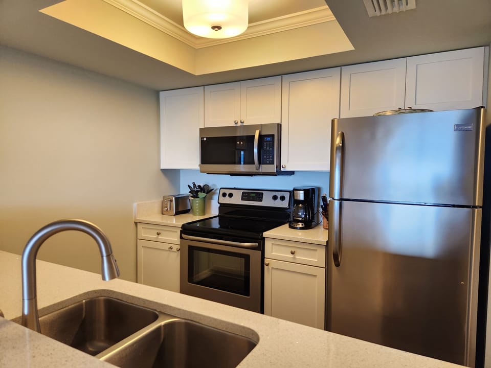 Kitchen fully equipped with microwave, dishwasher, coffeemaker, toaster and more