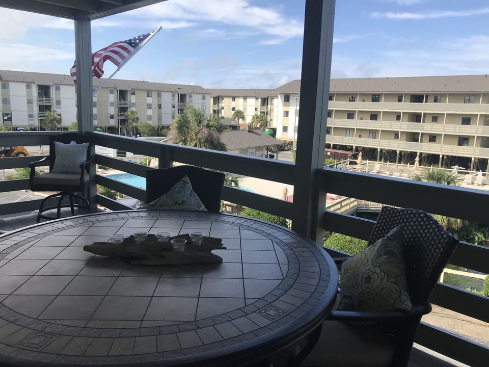 Huge deck overlooking pool and small pond with fountain