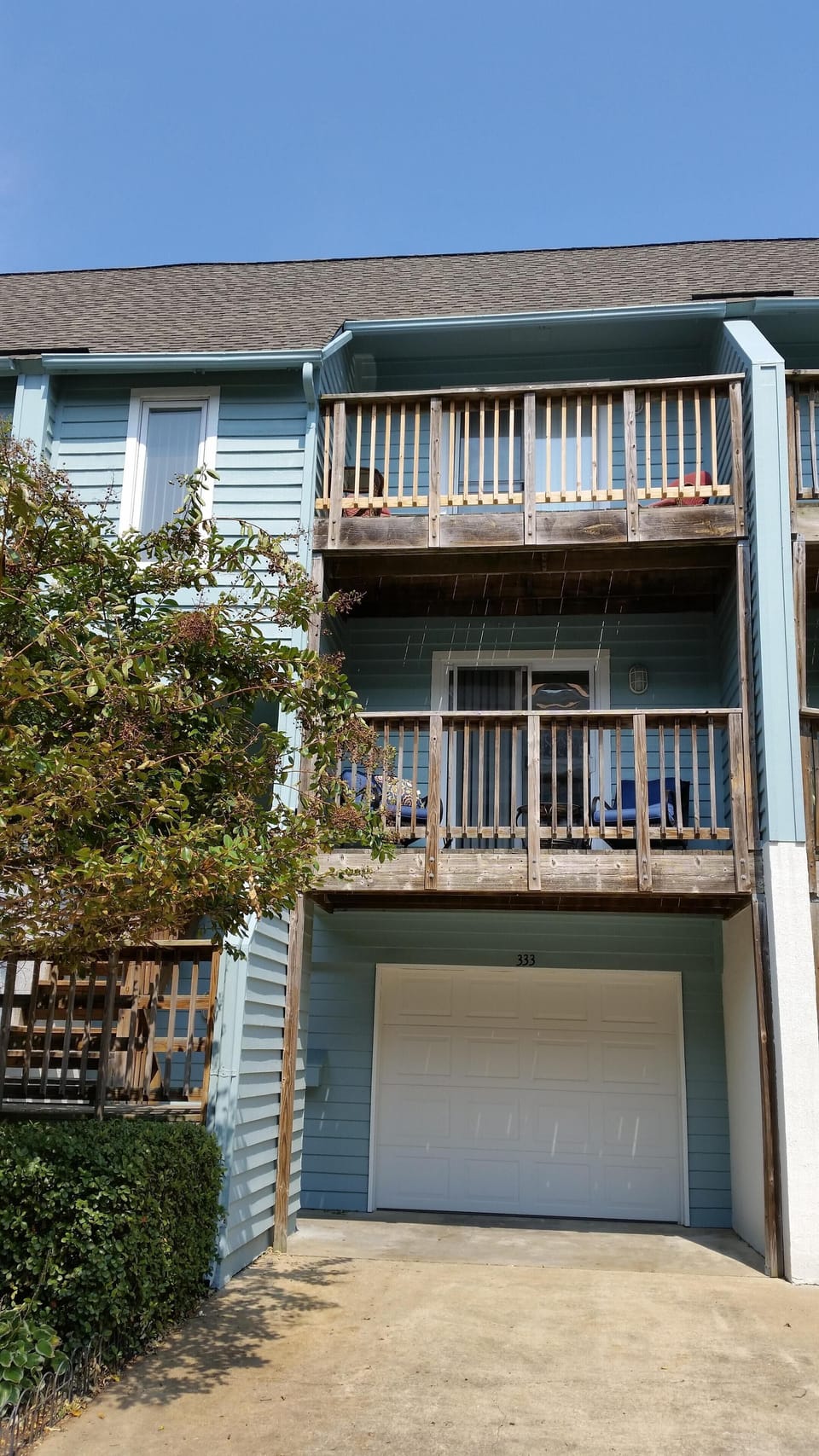 Front of condo showing garage and 2 decks.