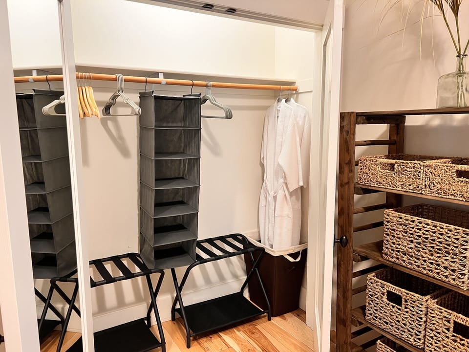 Spacious Closets with Robes and Luggage Racks