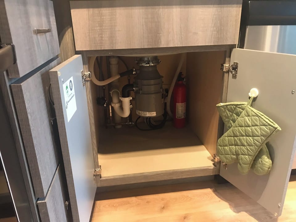 Fire extinguisher in kitchen cupboard 