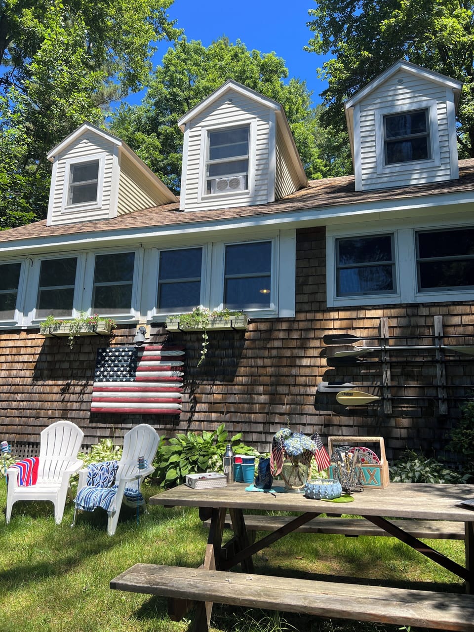 View of house from front yard - has hammock, fire pit, picnic table