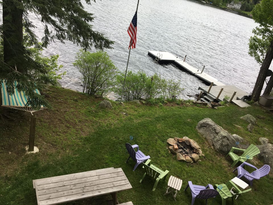 View of waterfront:  fire pit, dock, hammock, picnic table.  