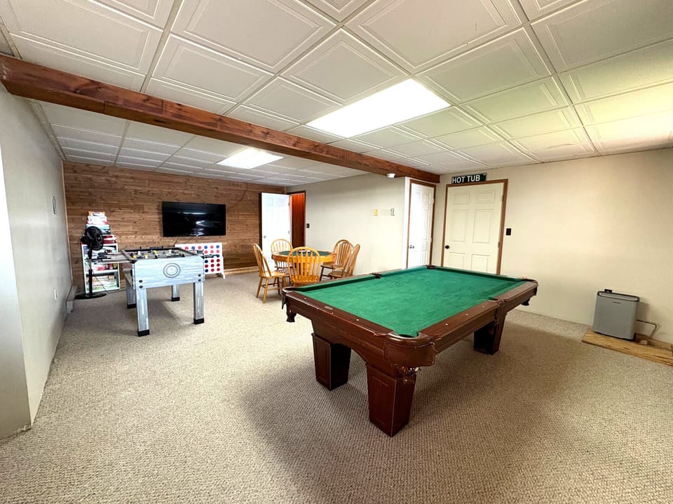 Lower level game room with views of lake and access to hot tub
