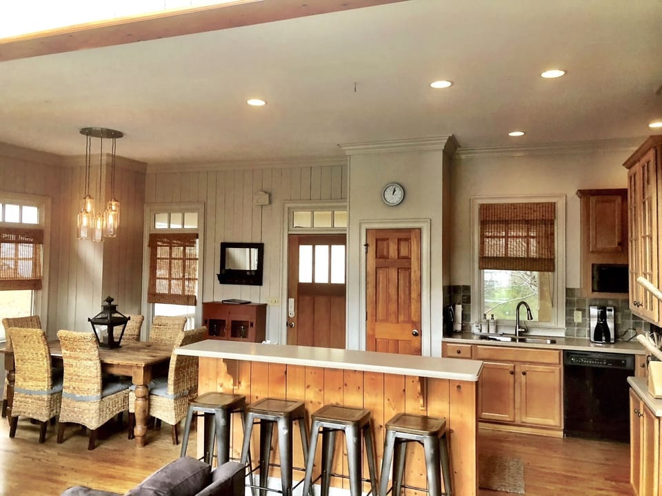 Open concept main floor kitchen dining and den