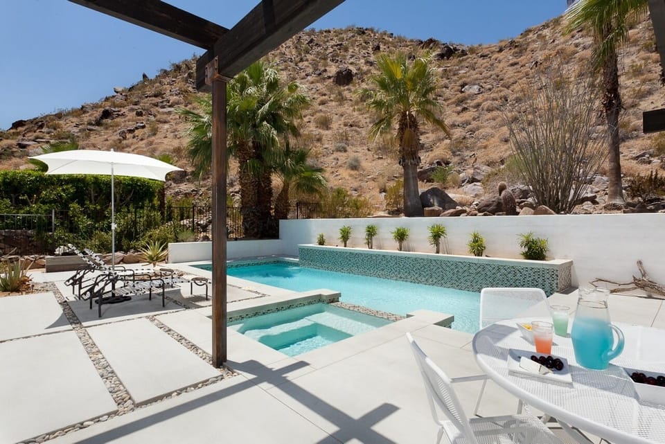 Relax hillside in this recently developed back patio and pool oasis