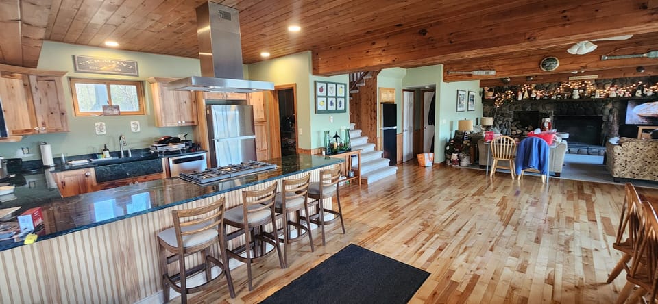 Great room features kitchen, dining and living room  areas.  two refrigerators. 