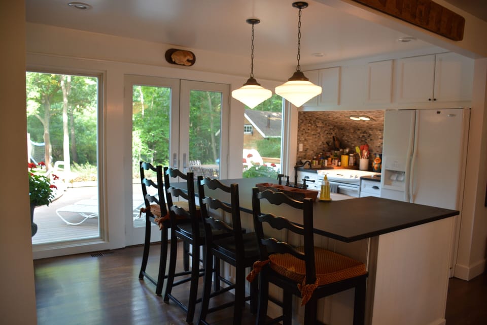 Large open kitchen. Chefs have 360 view of living room, dinning room and pool