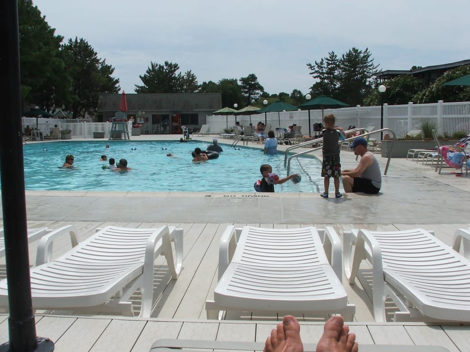 Pool area with chaise chairs and tables\chairs\umbrellas