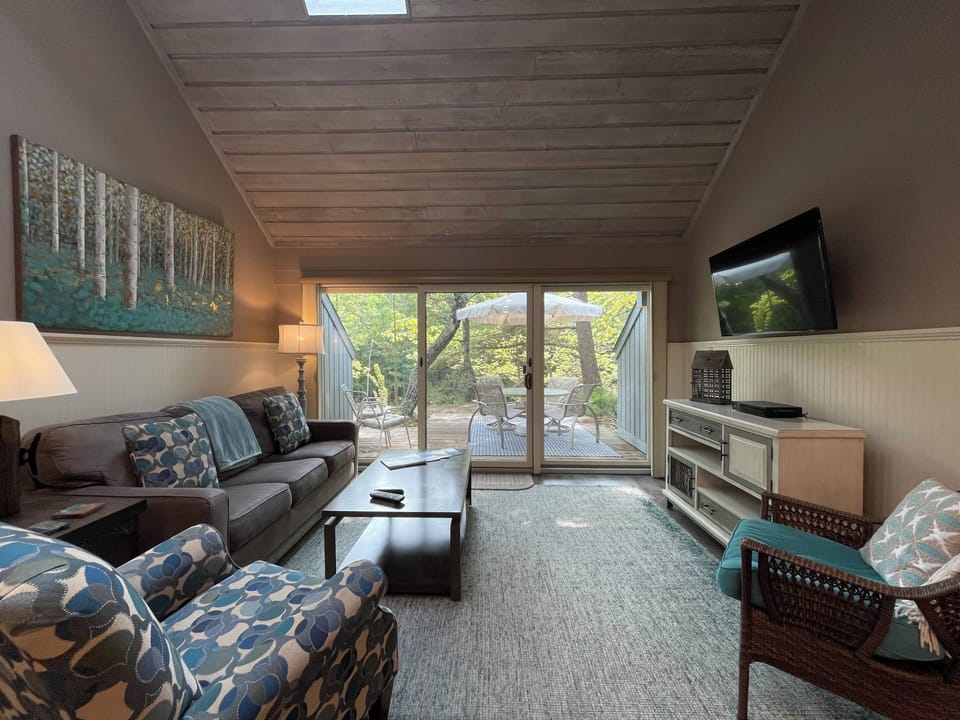 Lovely view from the living room of the woods beyond the patio.