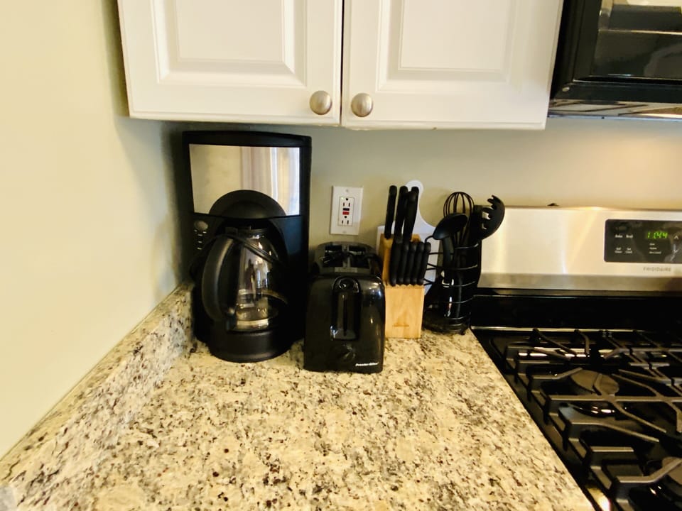 Coffee machine and cutlery throughout the kitchen
