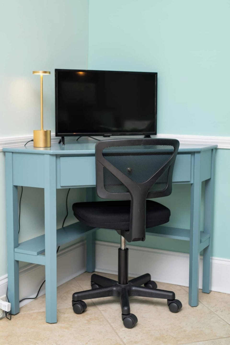 Work hard, relax harder! This cozy corner features a sleek desk setup with a comfy chair, desktop monitor, and reading light—ideal for checking emails or planning your next beach adventure.