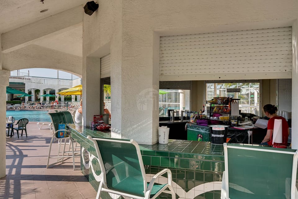 Enjoy some food and drinks by the pool tiki bar