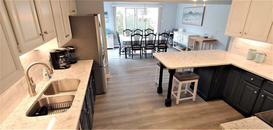 NEW huge kitchen , seats up to 12.   Bay window overlooks pool. Sliders to deck.