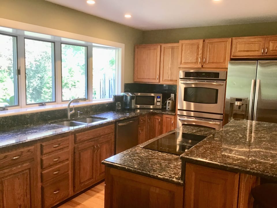  D/W, microwave, double oven, glass cooktop in new granite island that seats 3