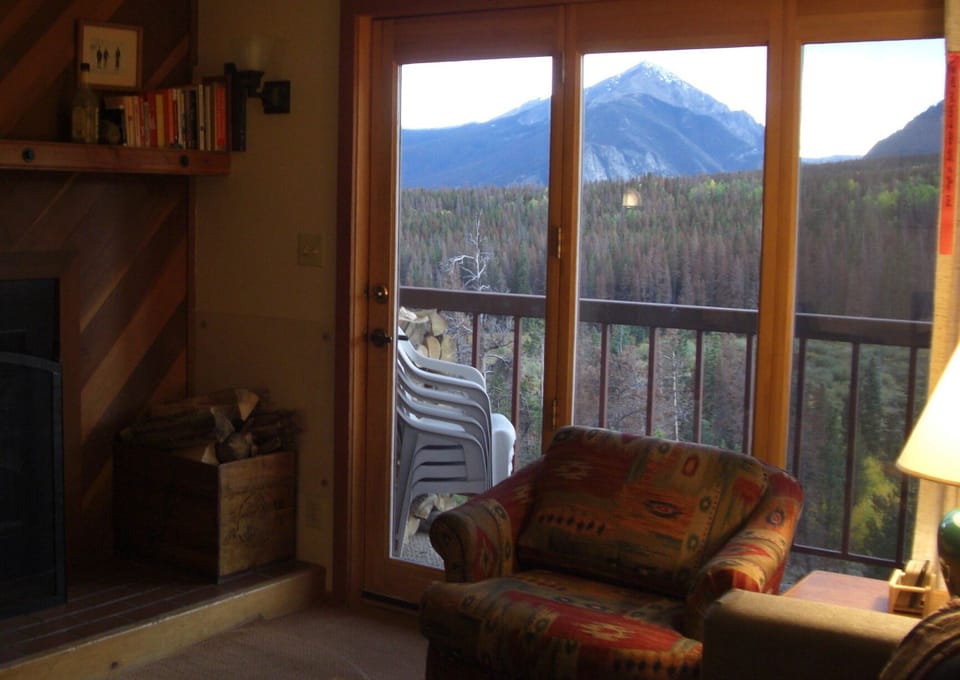 Living room view past deck to Ten Mile Range and White Mountain Nat'l Forest.