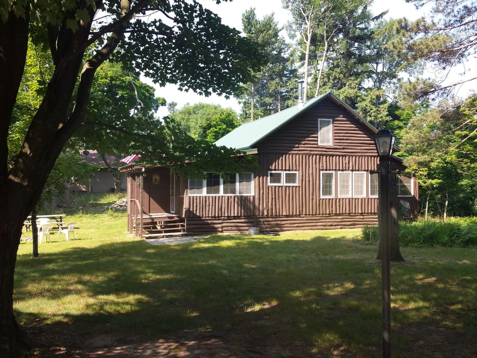 View of cottage at end of long driveway 