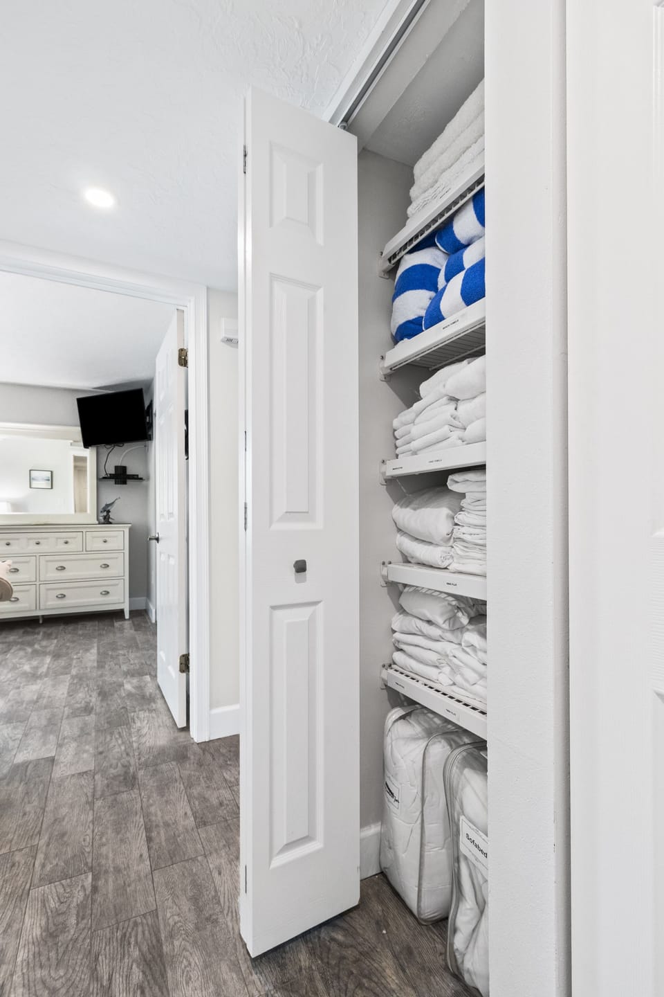 Fully Stocked Linen Closet in Hallway..