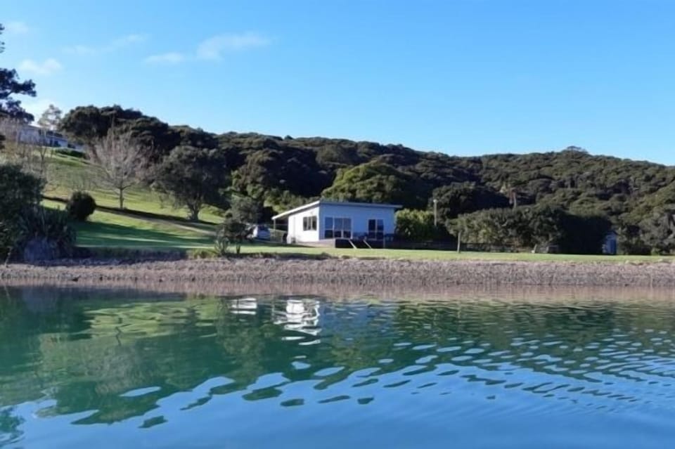 The bach from the water, nearly high tide