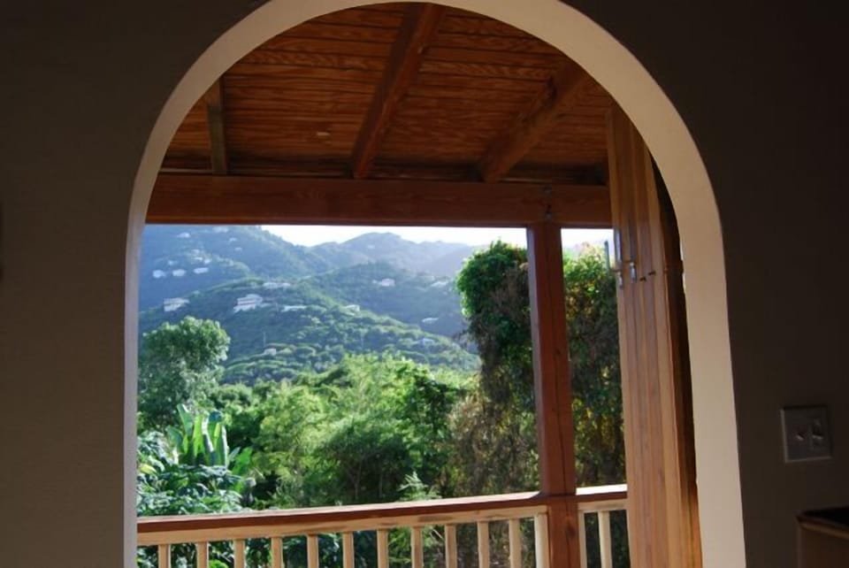 Arched door frames the quiet hill side