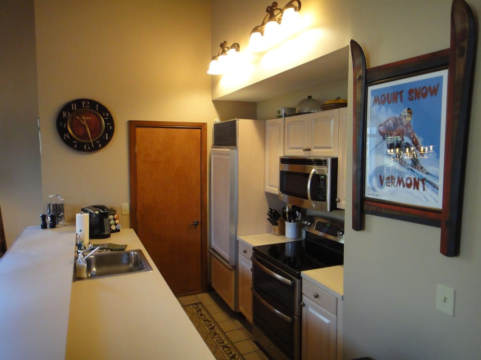 Kitchen with microwave, double oven, & large capacity  front load washer & dryer