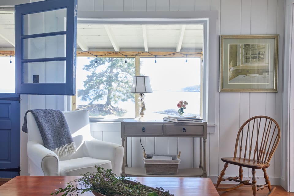 seating area next to the picture window with a view of the ocean
