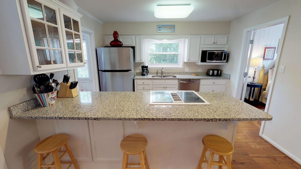 Kitchen counter bar-top with three stools 