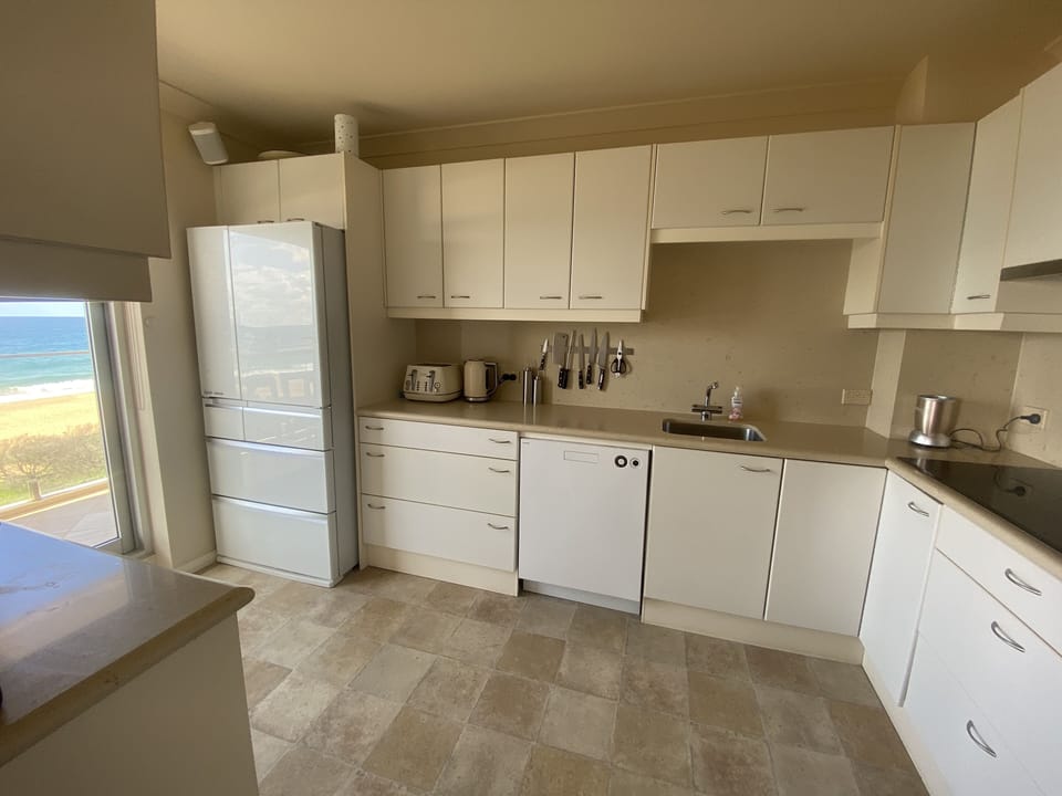 Full kitchen with toaster, kettle, microwave, induction stove and full size oven