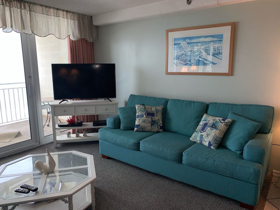 Living room with oceanfront balcony access