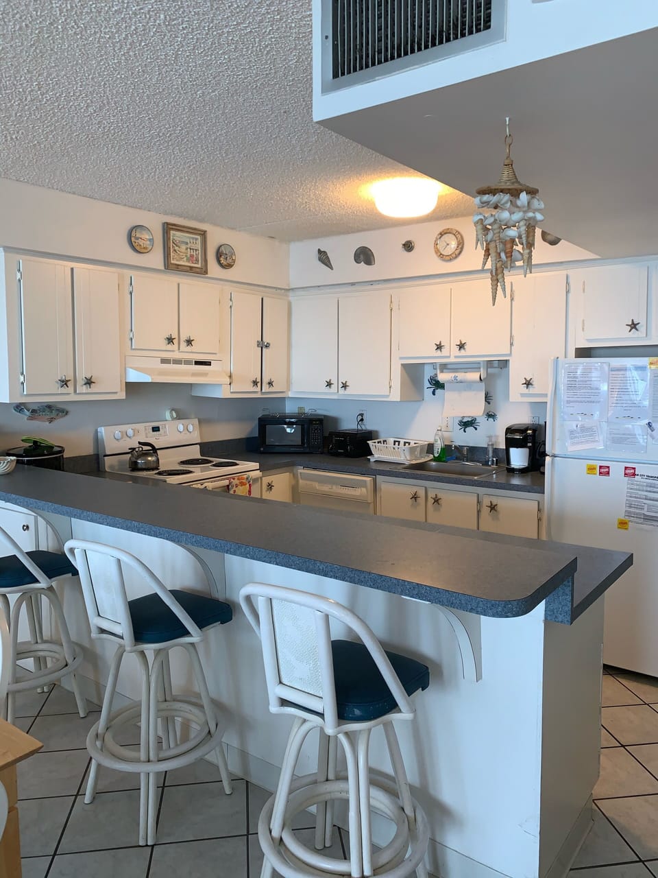 Kitchen peninsula seats three comfortably 