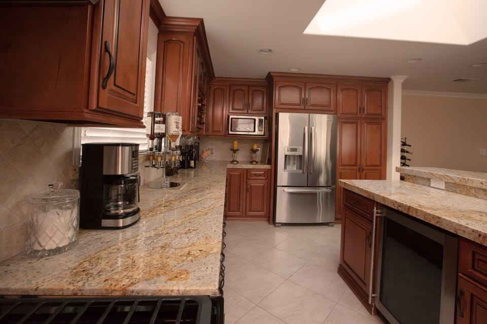 All wood custom cabinetry and granite counter tops.  Wine cooler in the island.