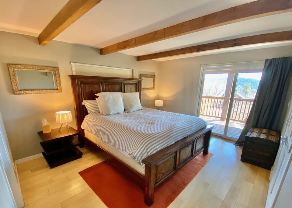 Bedroom #6 on bottom floor, King bed and access to deck