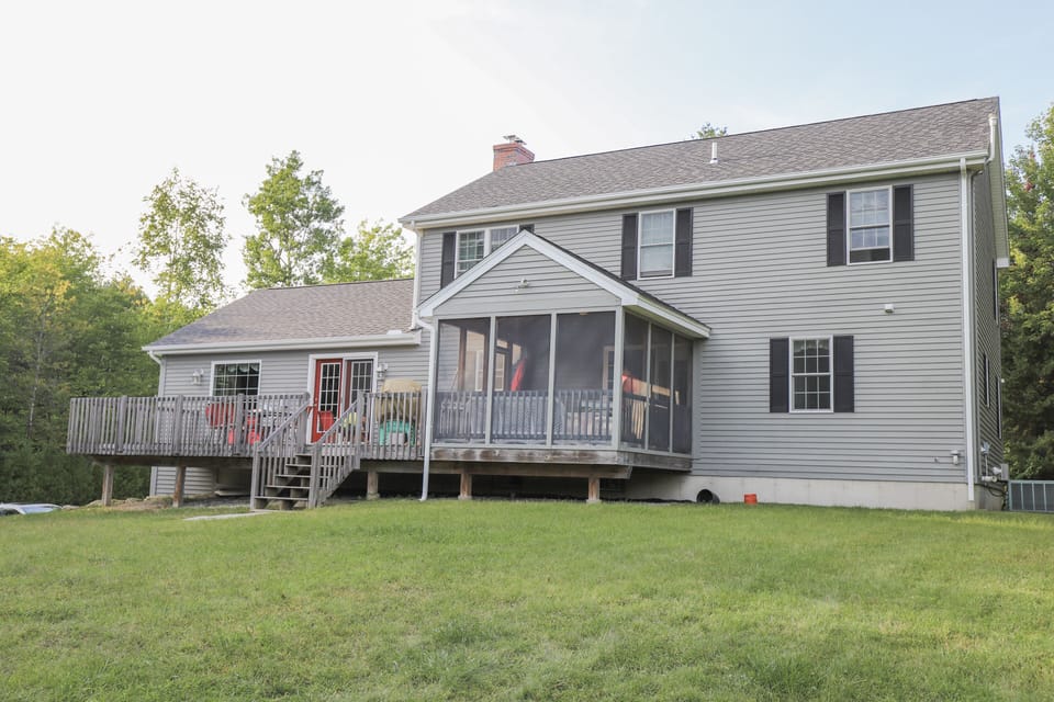 Back patio with propane grill, tables and chairs for 14 and a screened in porch