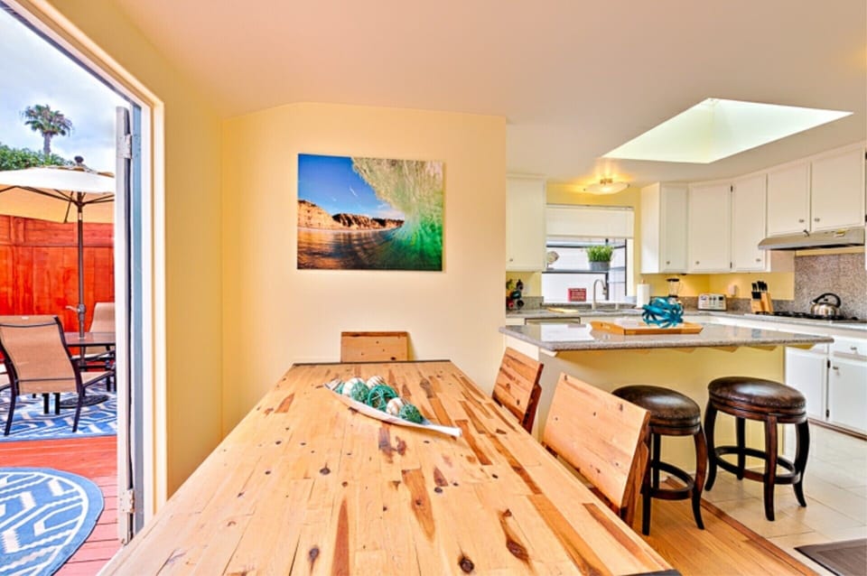 Dining area with seating for 6 + 2 at island. French doors leading out to patio