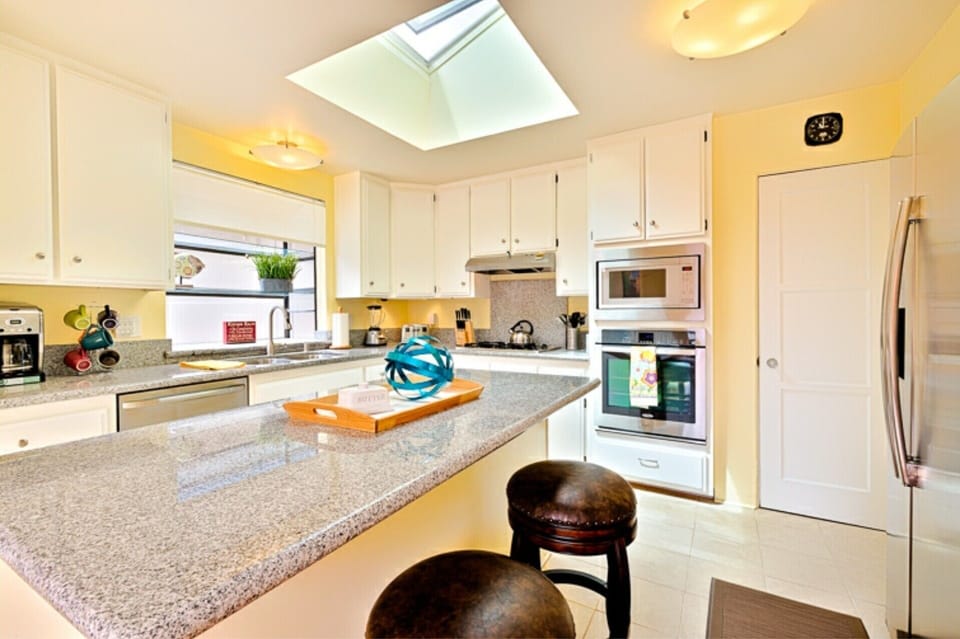 Alternate view of kitchen. Breakfast bar for 2. Ample light supplied by skylite