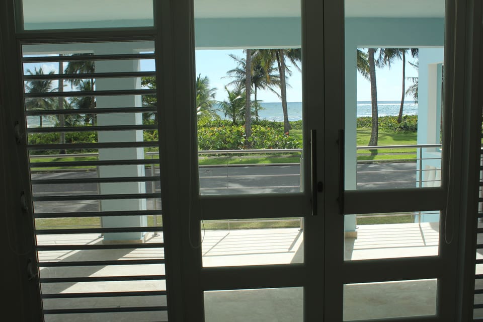 View of the side porch and the ocean from the living room.