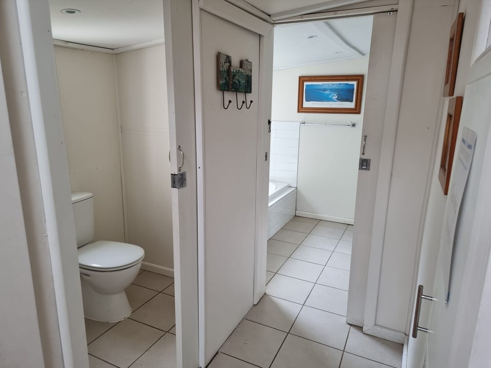 The toilet has a separate basin, whilst the bathroom as a bath, shower and basin