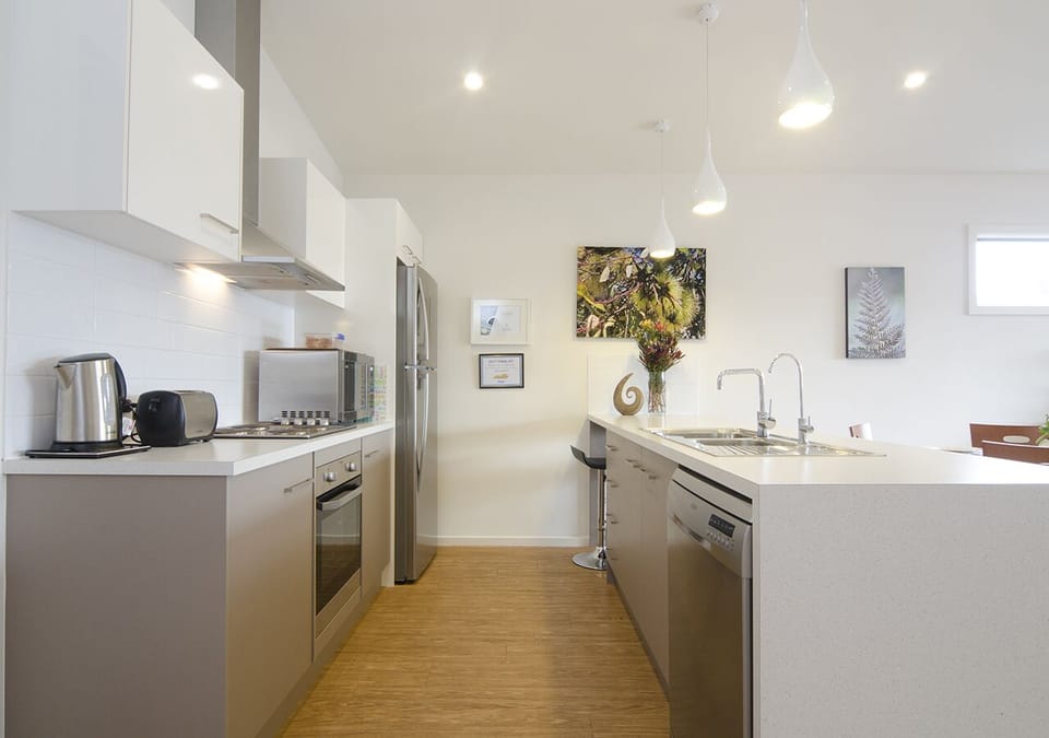 Fully equipped kitchen with cook top, oven, microwave and dishwasher.