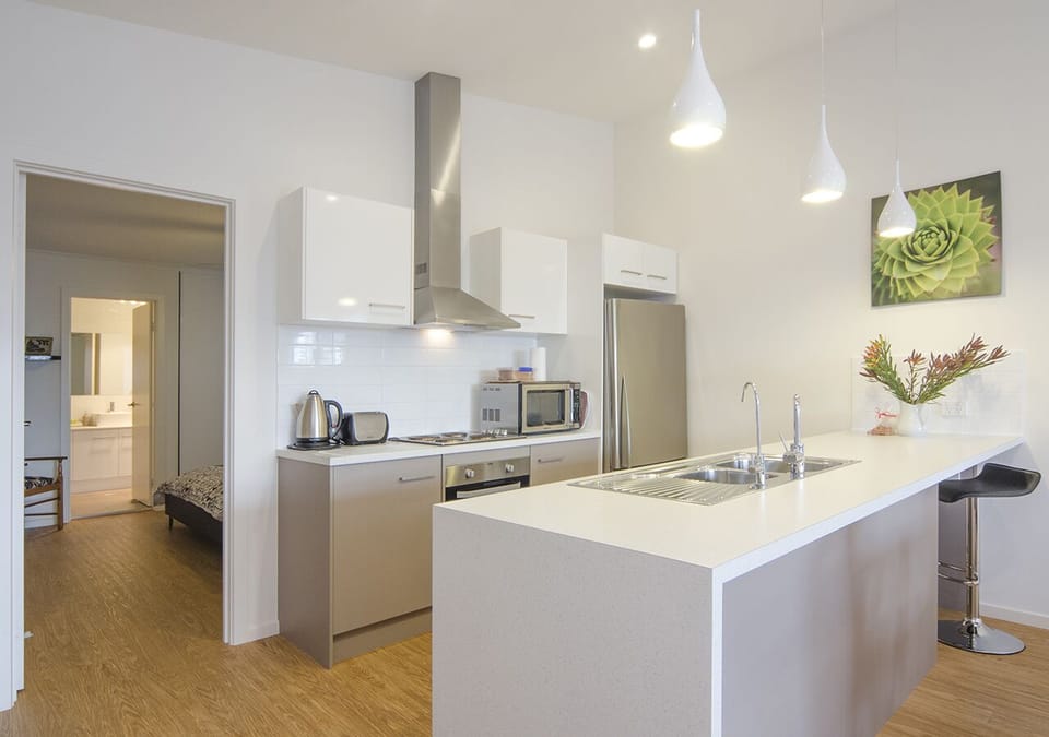 Modern kitchen with Maxwell Williams crockery, glasses and Jamie Oliver cookware