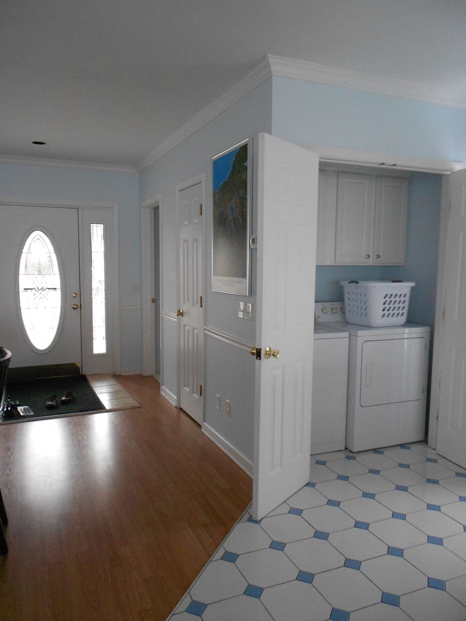 First floor: Entry with view of full-size washer/dryer off the kitchen