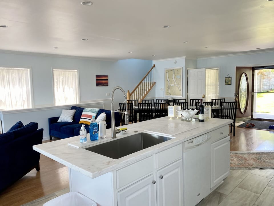 View from kitchen area overlooking living room, dining area and entryway. 