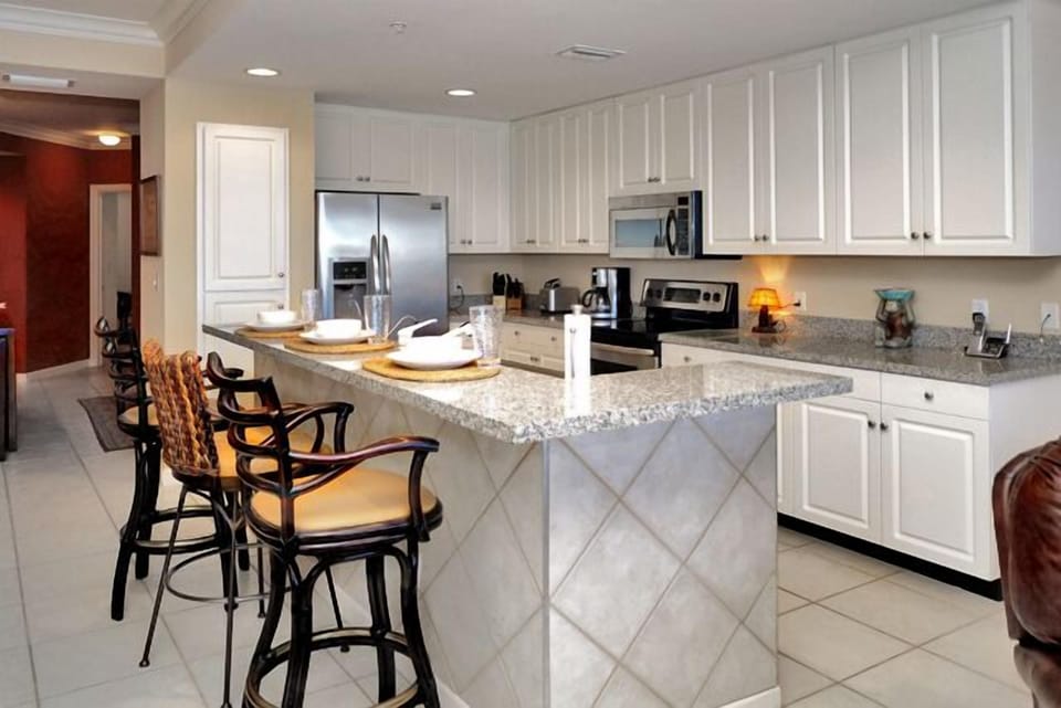 High end appliances in the kitchen and a breakfast bar too!