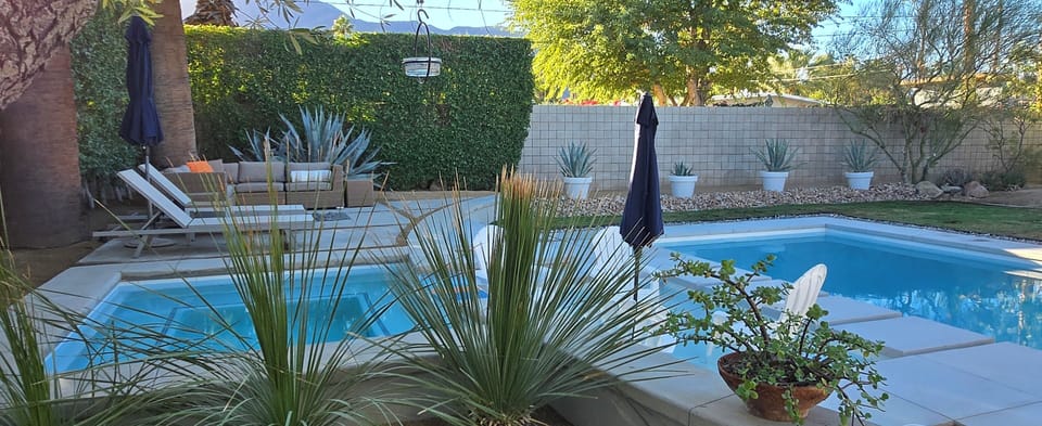 Spectacular desert landscaping surrounding pool, spa and wading area
