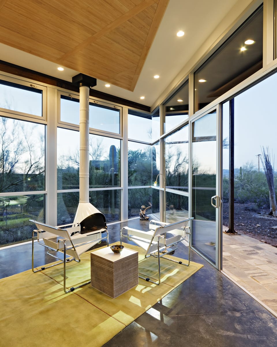 Recessed lighting throughout, sliding doors leading to one of two stone decks 