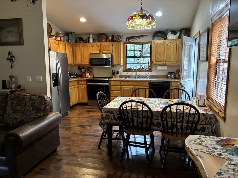 Spacious eat-in kitchen with front entrance leading to propane gas grill.