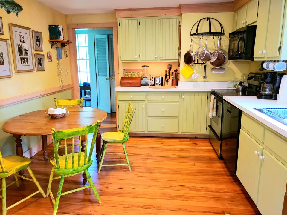 Eat-in kitchen with French doors leading you onto the  screened dining porch