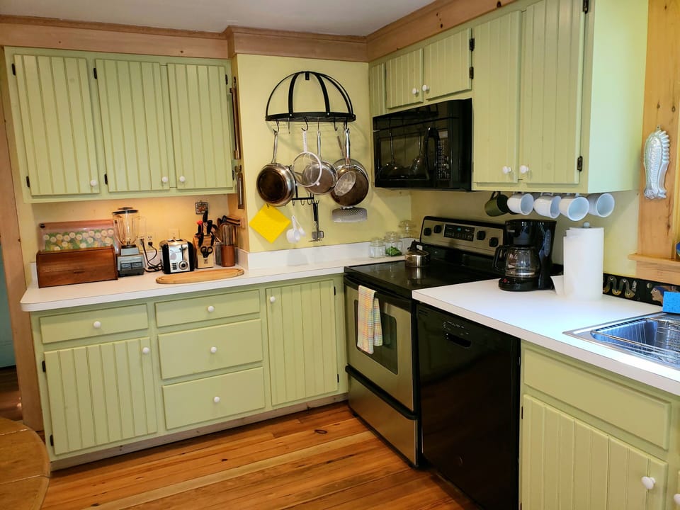 Eat-in kitchen with French doors leading you onto the  screened dining porch
